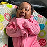 Nova is registered to the contest to win money with this photo: baby, infant, child, smiling, happy, portrait, pink_outfit, indoors, cushion, sofa, leather_sofa, home, face, eyes, open_mouth, sitting, patterned_fabric, colorful, natural_light, photography