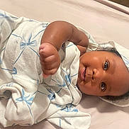 Nova joined the competition — help win amazing prizes! newborn, baby, infant, child, face, eyes, swaddled, blanket, hospital, bed, portrait, lying_down, raised_fist, cozy, indoors, bedding, brown_skin, dark_hair, wide_eyes, photography