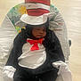 Zyair is registered to the contest to win money with this photo: baby, sleeping, costume, cat_in_the_hat, hat, red_bow, black_and_white, baby_rocker, giraffe_pattern, child, indoors, cute, soft_lighting, resting, infant, plush, clothing, adorable, peaceful, young_child