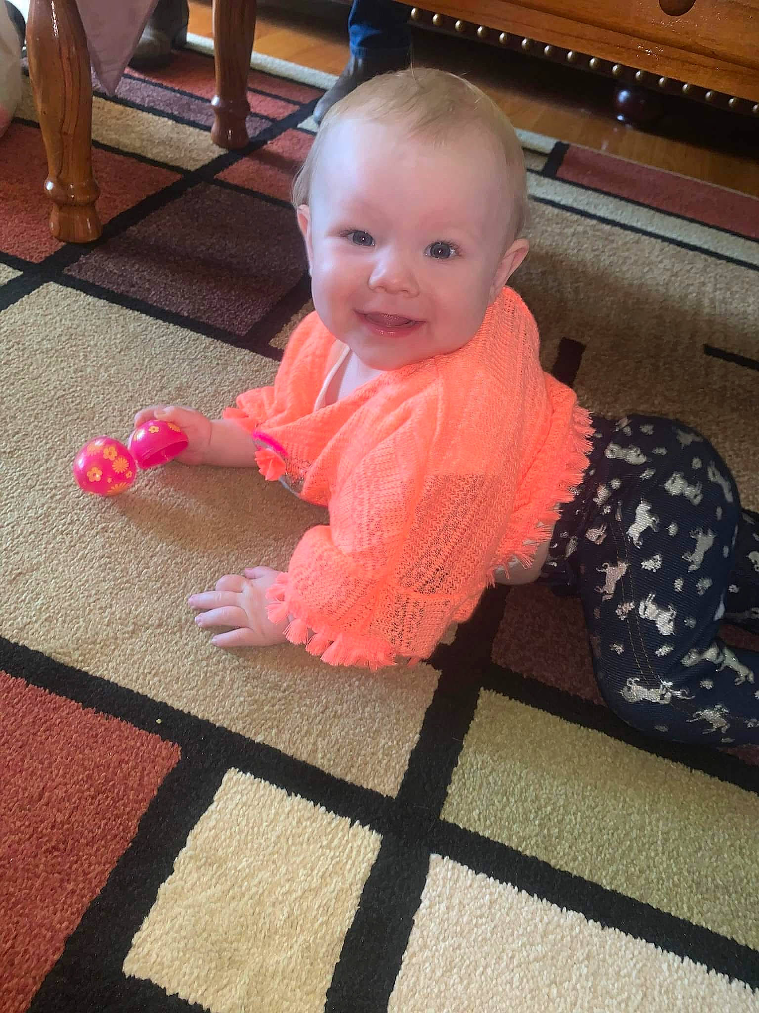 Lorraine is registered to the contest to win money with this photo: baby, baby_toddler_clothing, carpet, cheek, child, eye, floor, flooring, fun, happy, hardwood, head, magenta, pattern, person, skin, sleeve, smile, toddler, varnish