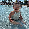 casual_clothing, child, clouds, daytime, fun, happy, outdoor, people, play, pool, sitting, sky, splashing, summer, sunlight, swimming, toddler, trees, water, wet_hair