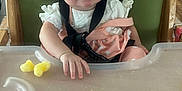 Klay-Cee joined the competition — help win amazing prizes! baby, high_chair, smile, child, food, snack, plastic_tray, clothing, indoor, person, wooden_floor, face, seat, straps, pink, white, hand, cute, happy, infant