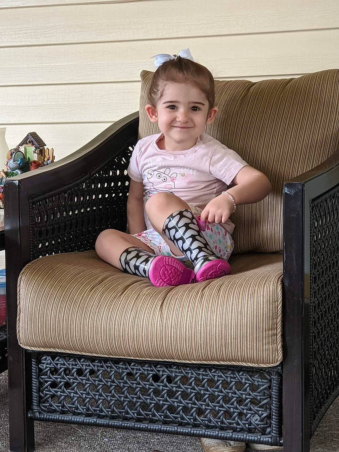 Addisyn joined the competition — help win amazing prizes! baby, chair, child, comfort, couch, furniture, home, house, interior_design, joy, leg, person, pink, play, product, room, sitting, table, toddler, wicker