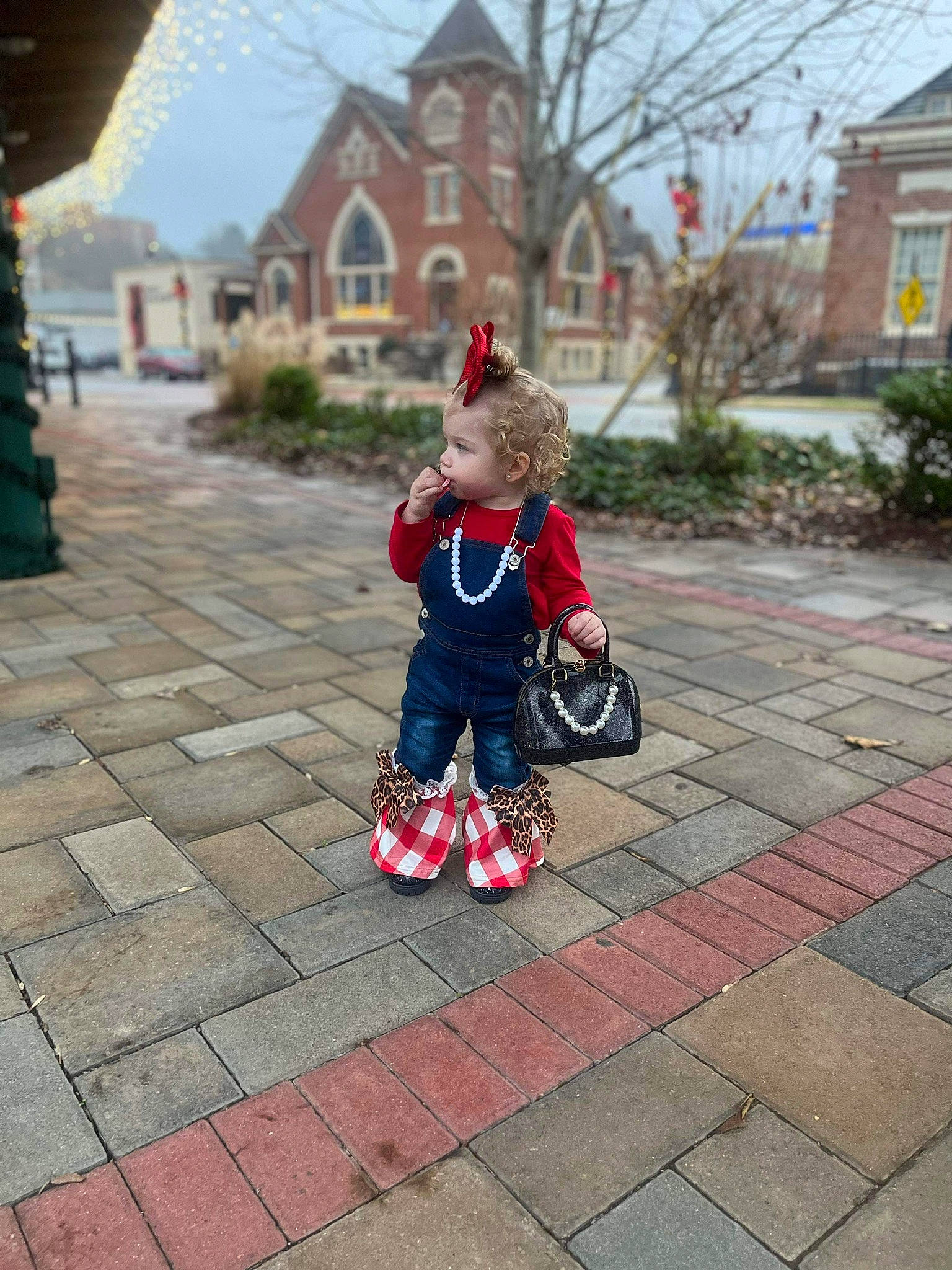 Paizley is registered to the contest to win money with this photo: asphalt, baby_carriage, city, flooring, grass, house, leg, leisure, person, plant, recreation, road, road_surface, sidewalk, sky, tire, toddler, tree, urban_area, wheel