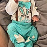 Braxton is registered to the contest to win money with this photo: baby, infant, child, yawning, cute, turquoise, white_clothing, bow_tie, bunny_ears, blanket, soft, sleepwear, lying_down, cozy, indoors, newborn, small_hands, comfortable, expression, face