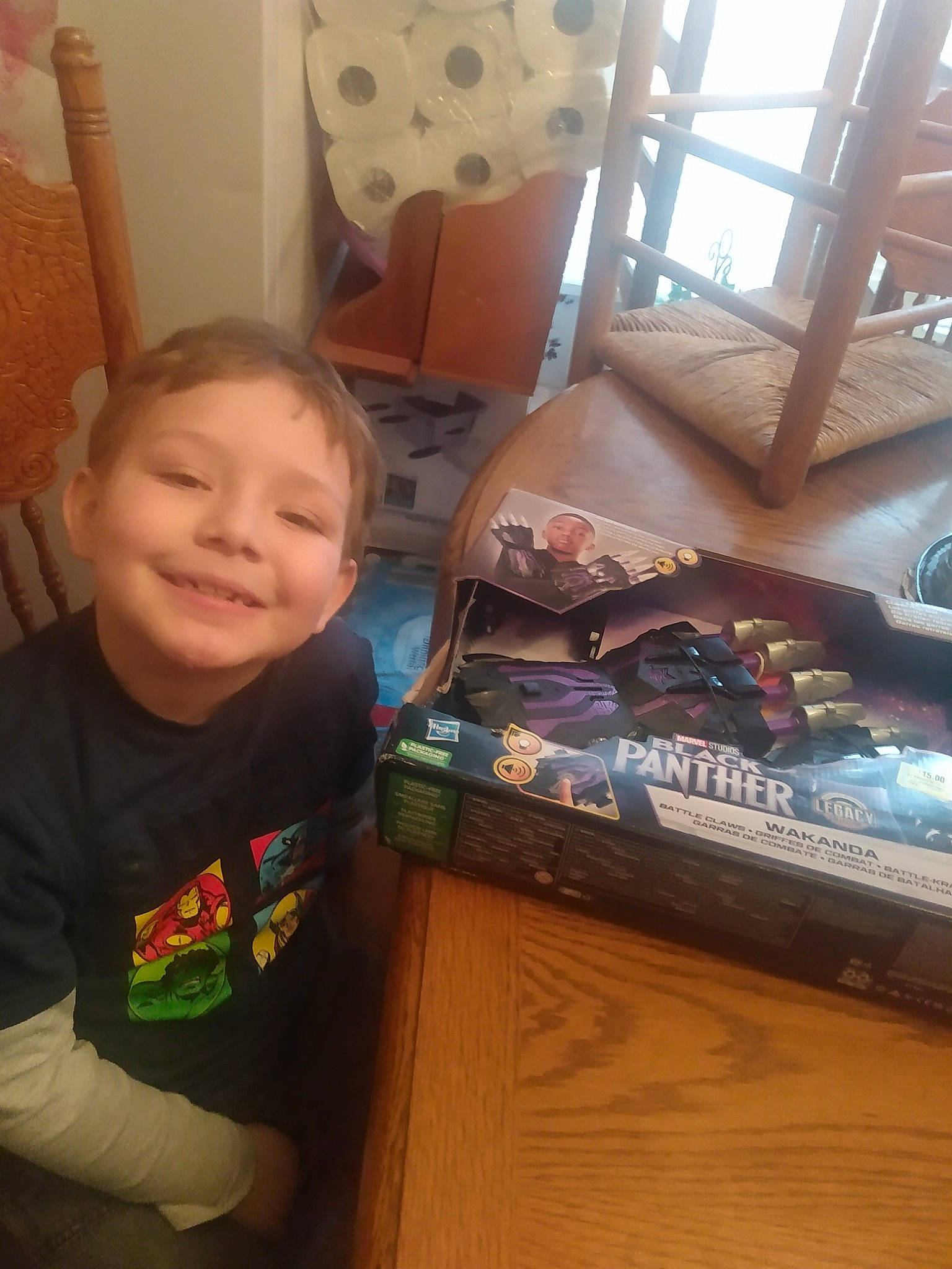 Chandler is registered to the contest to win money with this photo: baby, chair, child, couch, electronic_device, floor, flooring, fun, happy, hardwood, joy, living_room, person, play, room, sitting, smile, t_shirt, table, technology