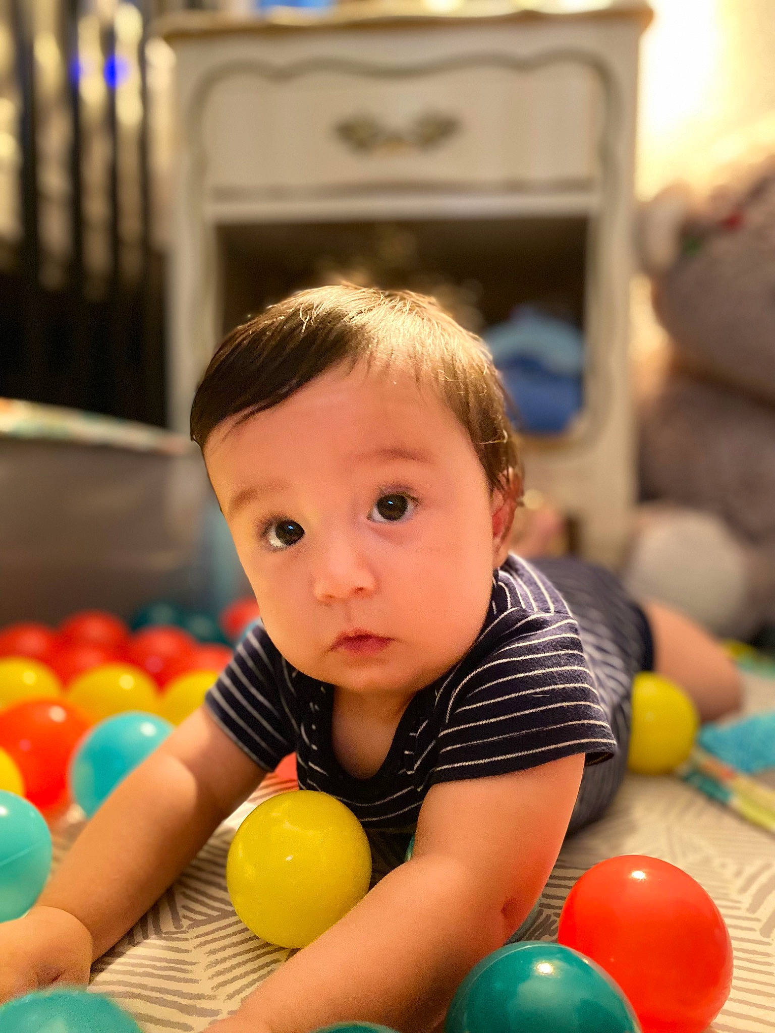 Beau is registered to the contest to win money with this photo: baby, baby_playing_with_toys, ball, ball_pit, child, flooring, fun, happy, indoor_games_and_sports, leisure, party_supply, person, play, recreation, room, sports_equipment, sports_toy, surprise, television, toddler