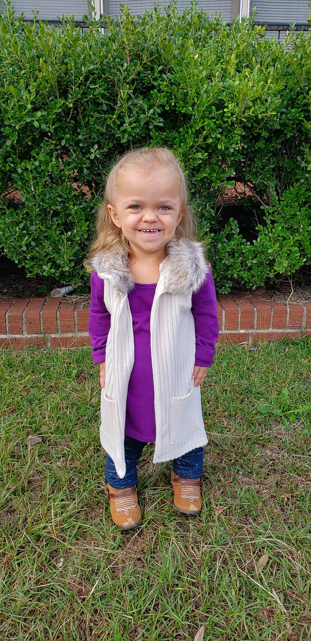 Cheyanne is registered to the contest to win money with this photo: child, child_model, clothing, grass, jacket, joy, lawn, long_hair, outerwear, person, plant, purple, smile, toddler