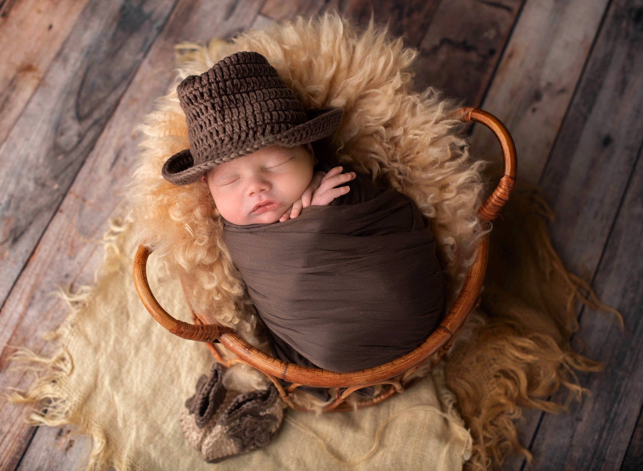 Arlo is registered to the contest to win money with this photo: cap, carnivore, comfort, fashion_accessory, fawn, fun, fur, fur_clothing, grass, headgear, headwear, natural_material, person, rope, sitting, smile, toddler, winter, wood, wool
