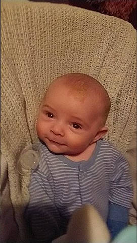 Leonard is registered to the contest to win money with this photo: baby, cheek, child, chin, close_up, ear, eye, eyebrow, face, facial_expression, forehead, head, iris, lip, mouth, nose, person, sitting, skin, smile