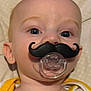 Dino joined the competition — help win amazing prizes! baby, pacifier, mustache, infant, face, blue_eyes, clothing, yellow_trim, onesie, cute, lying_down, close_up, soft_surface, skin, head, ears, expression, funny, indoors, child