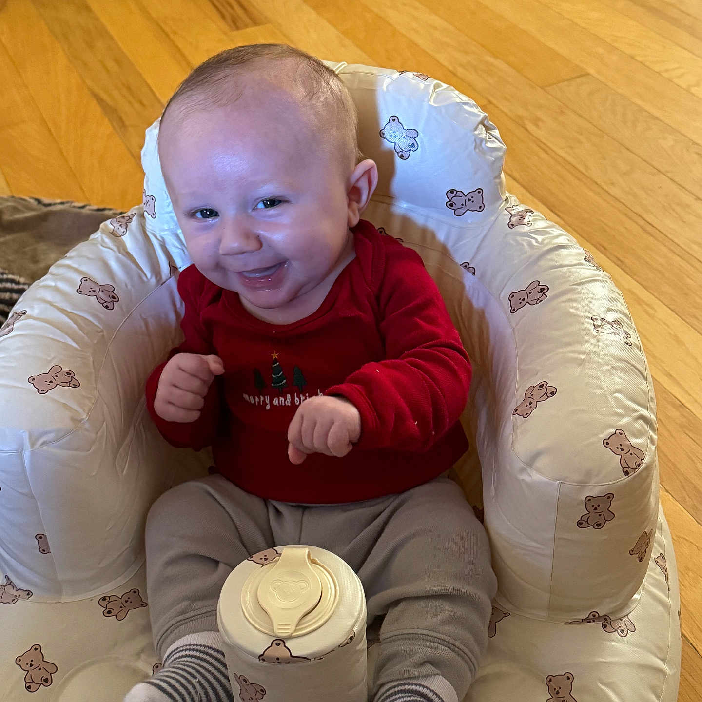 Maverick is registered to the contest to win money with this photo: baby, bodypart, clothing, couch, cushion, face, finger, furniture, glove, hand, happy, hardwood, head, homedecor, hosiery, person, photography, portrait, sitting, wood