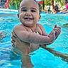 Aiden joined the competition — help win amazing prizes! baby, child, smiling, pool, water, wet, curly_hair, summer, outdoor, umbrella, happy, person, skin, hand, holding, blue, sunlight, family, vacation, fun
