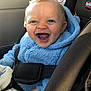 baby, child, smiling, car_seat, blue_jacket, fleece, happy, indoors, seatbelt, infant, cute, person, safety, car_interior, window, sunlight, portrait, clothing, young_child, human