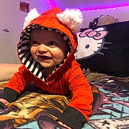 Noah joined the competition — help win amazing prizes! baby, bedroom, blanket, butterfly_stickers, cute, eyes, fluffy_ears, grin, hands, hello_kitty_pillow, hoodie, indoor, infant, led_lights, orange_hoodie, pillow, plush_toy, portrait, purple_lights, smile