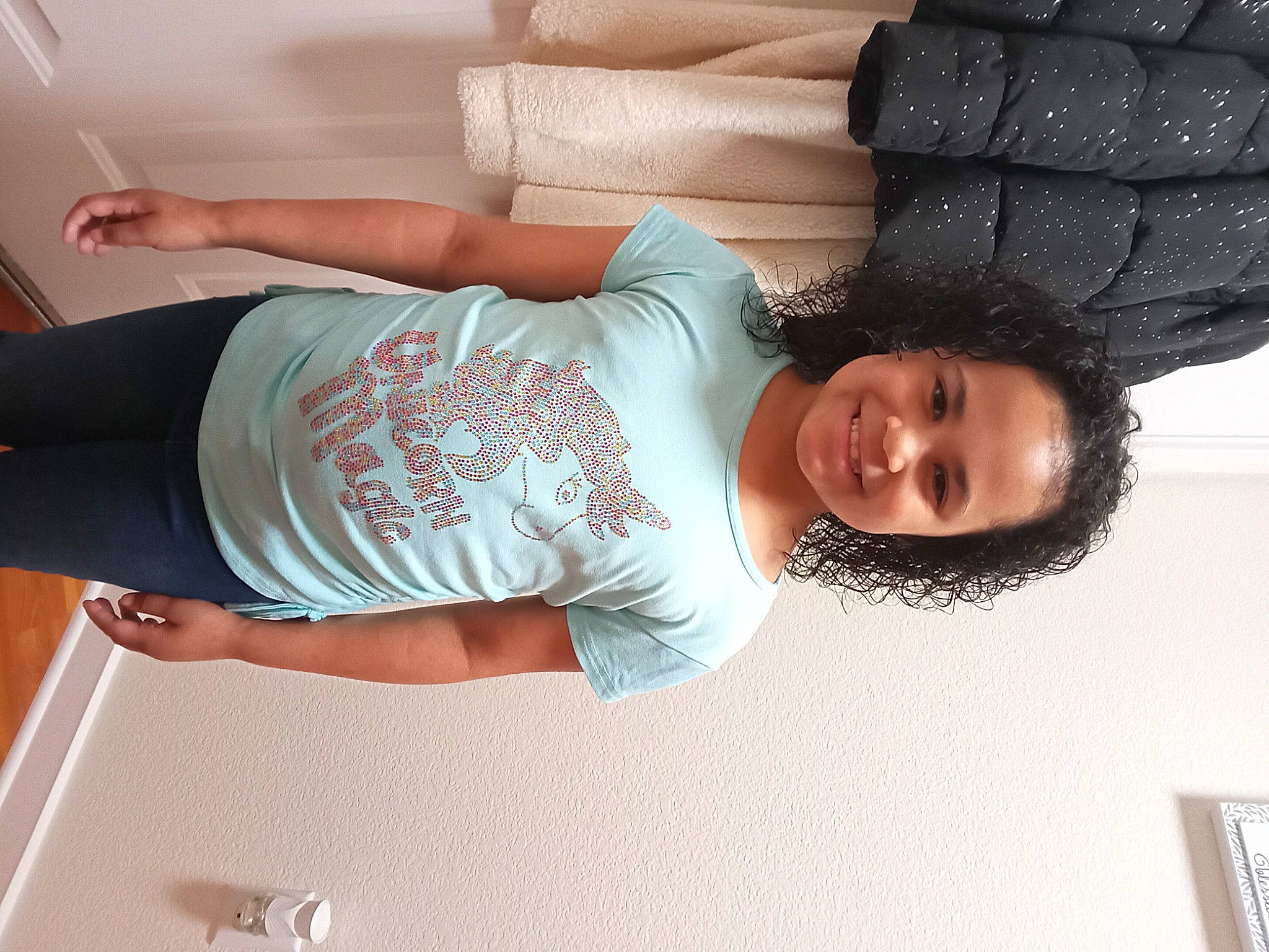 Jaida is registered to the contest to win money with this photo: arm, chest, child, comfort, elbow, fashion, fun, hand, happy, human_body, human_leg, joint, joy, leg, leisure, person, shoulder, sleeve, smile, t_shirt