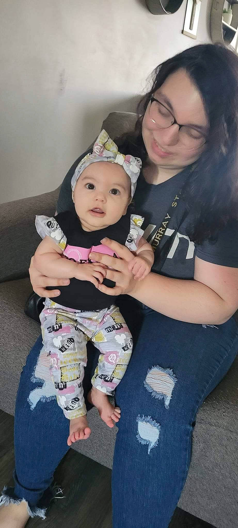 Esmeralda is registered to the contest to win money with this photo: arm, baby, baby_toddler_clothing, beauty, black_hair, child, clothing, eyewear, face, finger, fun, gesture, hairstyle, happy, head, headwear, joy, leg, person, skin