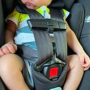 Briggs is registered to the contest to win money with this photo: baby, sleeping, car_seat, safety_harness, pacifier, infant, child, seat_belt, relaxed, cute, small_hands, small_feet, clothing, black_car_seat, close_up, indoors, peaceful, resting, newborn, toddler