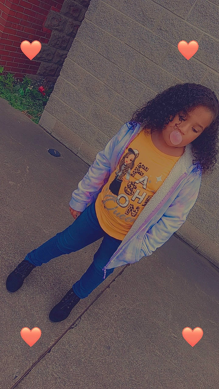 Vanessa is registered to the contest to win money with this photo: asphalt, cool, denim, electric_blue, flooring, fun, human_leg, knee, magenta, orange, pattern, person, road_surface, sleeve, sportswear, standing, t_shirt, textile, thigh, tints_and_shades