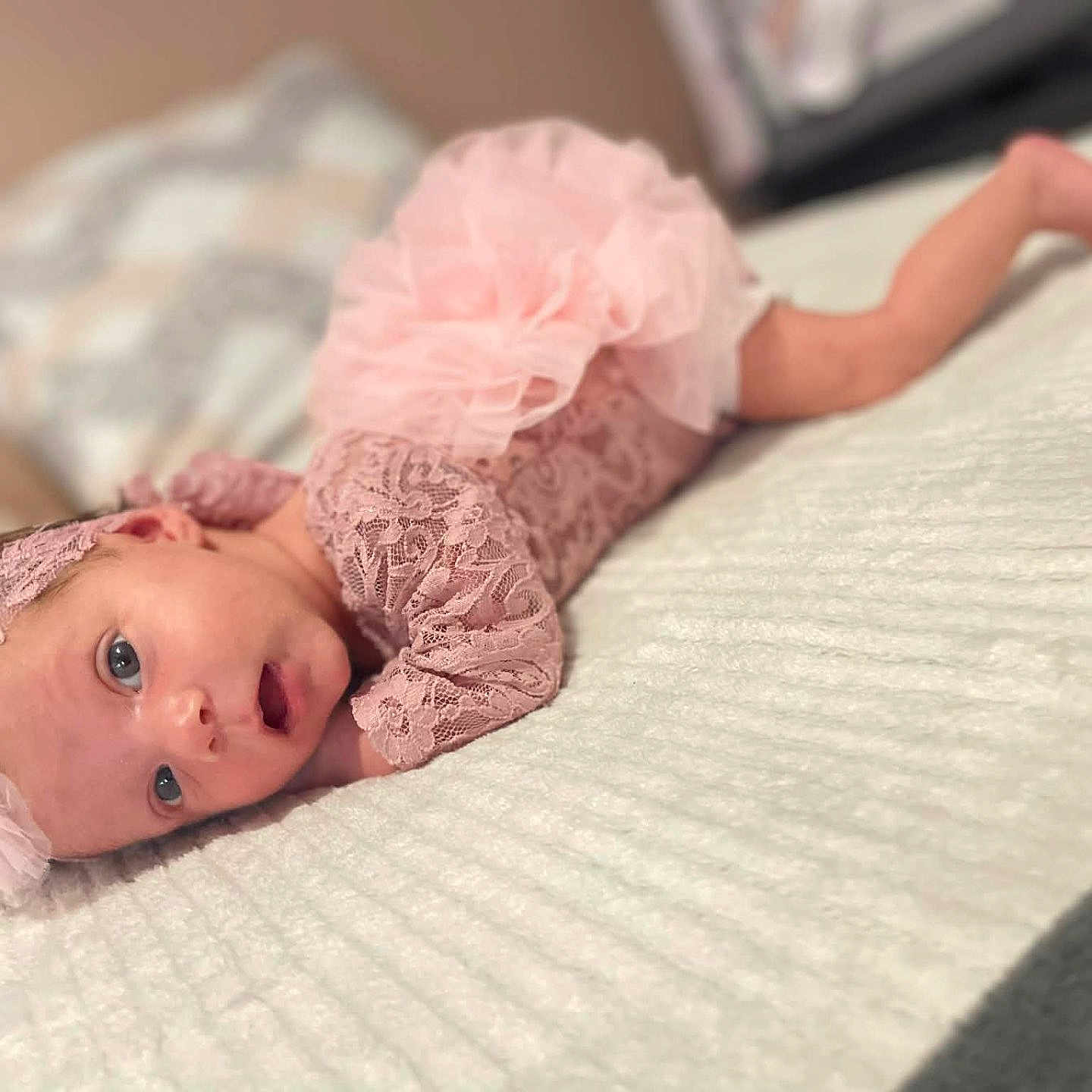 Melissa participe au concours pour gagner de l'argent avec cette photo : baby, infant, pink_clothing, lace, headband, tummy_down, blanket, bed, pillow, soft_texture, cute, newborn, lying_down, portrait, indoors, child, person, sleepwear, baby_girl, resting