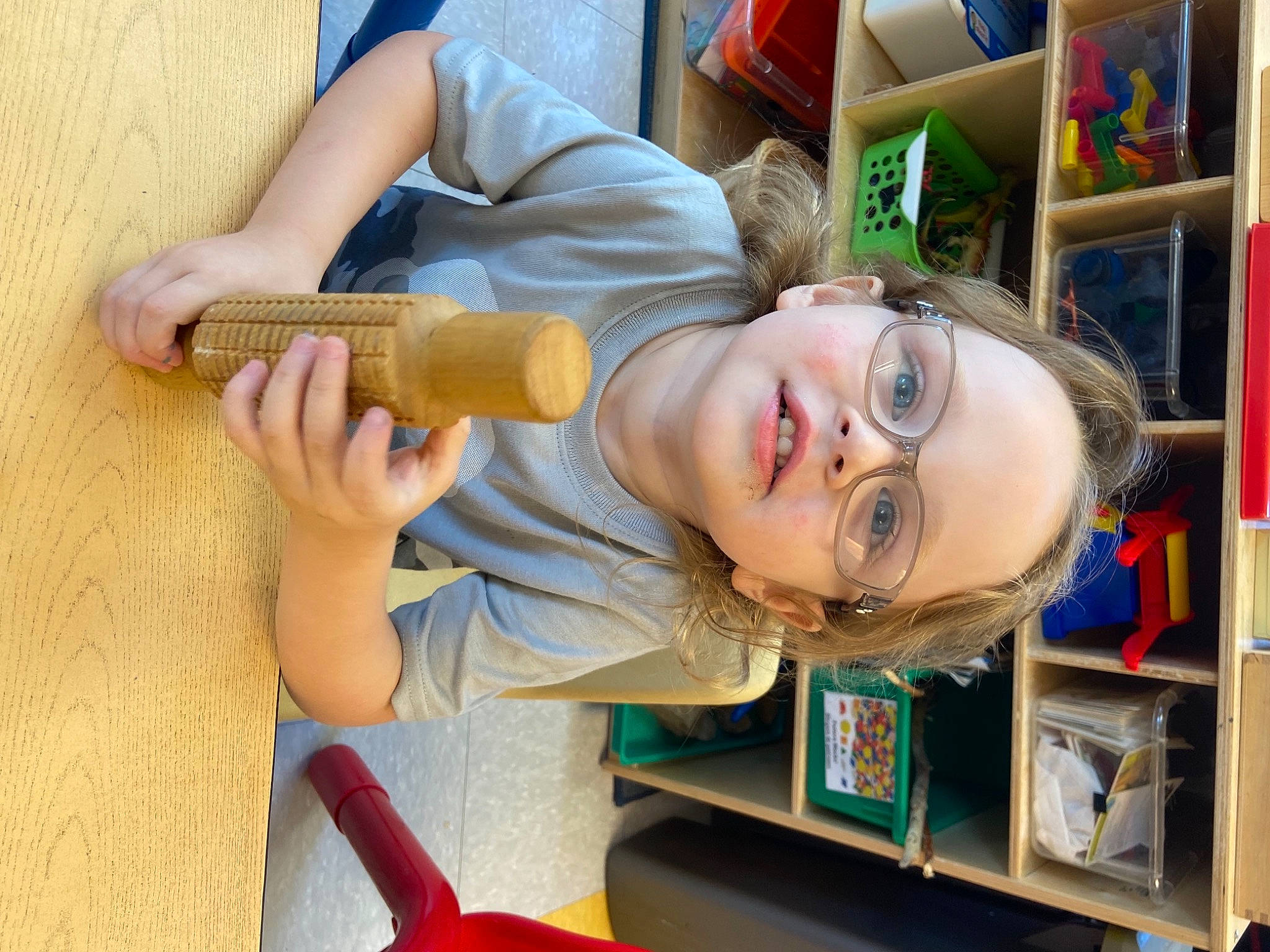 Jd is registered to the contest to win money with this photo: beer, bookcase, child, clothing, eyewear, fun, glasses, hand, happy, leisure, person, play, room, shelf, shelving, smile, t_shirt, tableware, wood