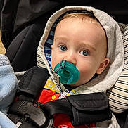 Everett joined the competition — help win amazing prizes! baby, blanket, blue_eyes, car_seat, child, closeup, clothing, comfort, cute, fabric, face, hoodie, indoor, infant, pacifier, portrait, seated, straps, toy_design, zipper