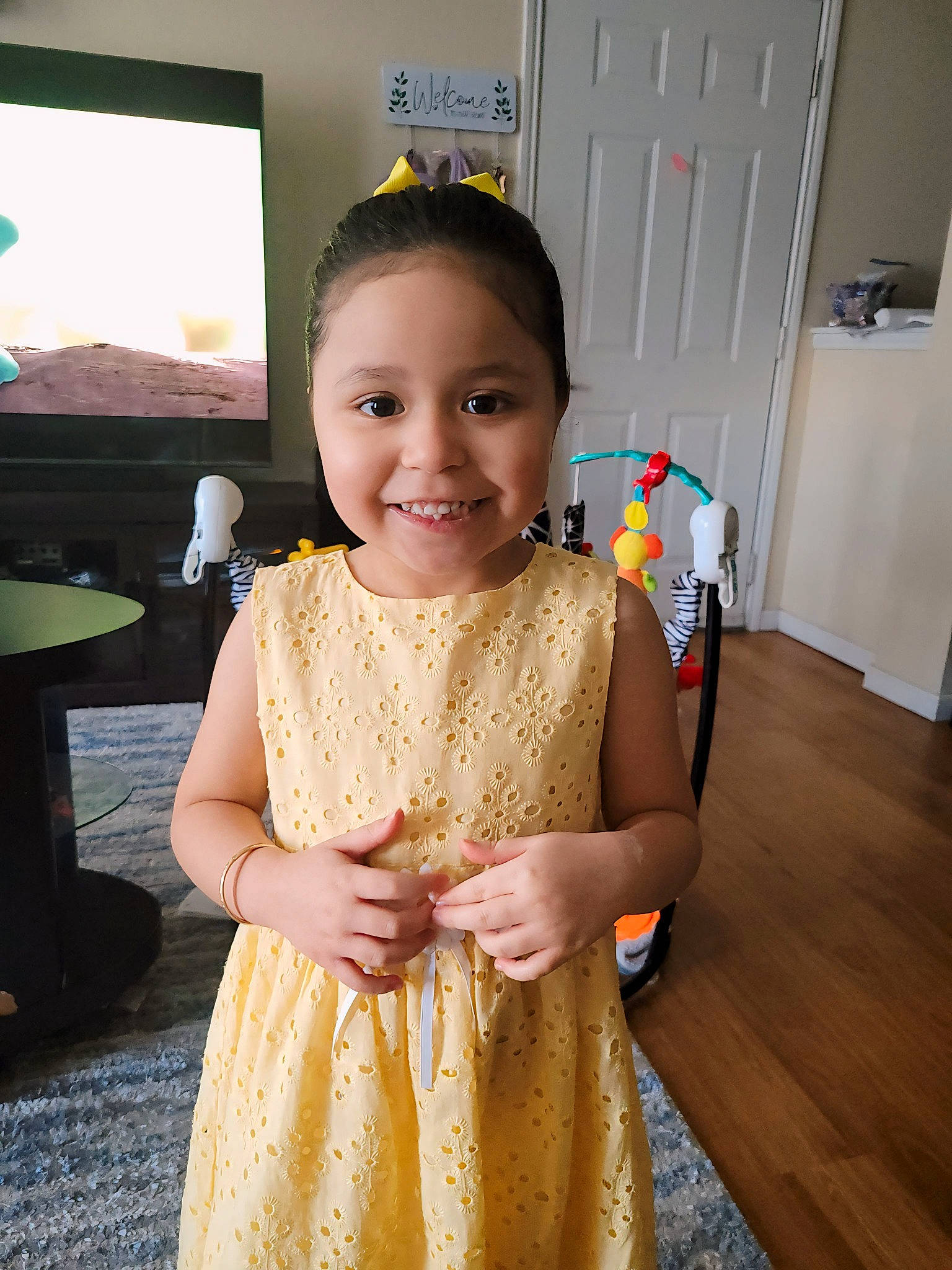 Adalicia is registered to the contest to win money with this photo: baby_toddler_clothing, child, day_dress, door, dress, embellishment, event, facial_expression, fashion_accessory, fashion_design, flooring, formal_wear, fun, hairstyle, happy, jewellery, joy, person, skin, sleeve