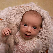 Evelyn is registered to the contest to win money with this photo: baby, infant, teddy_bear, knitted_toy, blanket, fluffy, soft_texture, portrait, cute, child, newborn, closeup, face, eyes, hand, clothing, lace, smile, warm, cozy
