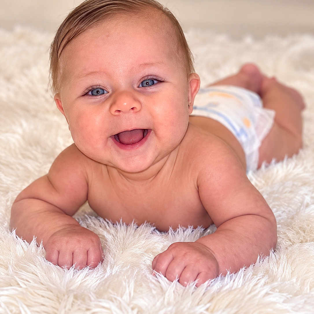 Aslhey joined the competition — help win amazing prizes! baby, infant, child, smiling, happy, portrait, tummy_time, lying_down, blanket, fluffy_blanket, diaper, blue_eyes, brown_hair, baby_face, indoors, close_up, soft_lighting, adorable, photography, cozy