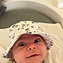 Aydèn a rejoint le concours — aidez-le/la à gagner de superbes lots ! apparel, baby, bathroom, bucket_hat, child, closeup, curious, cute, expression, eyes, face, hat, headwear, indoors, infant, laying, mickey_mouse, person, skin, towel