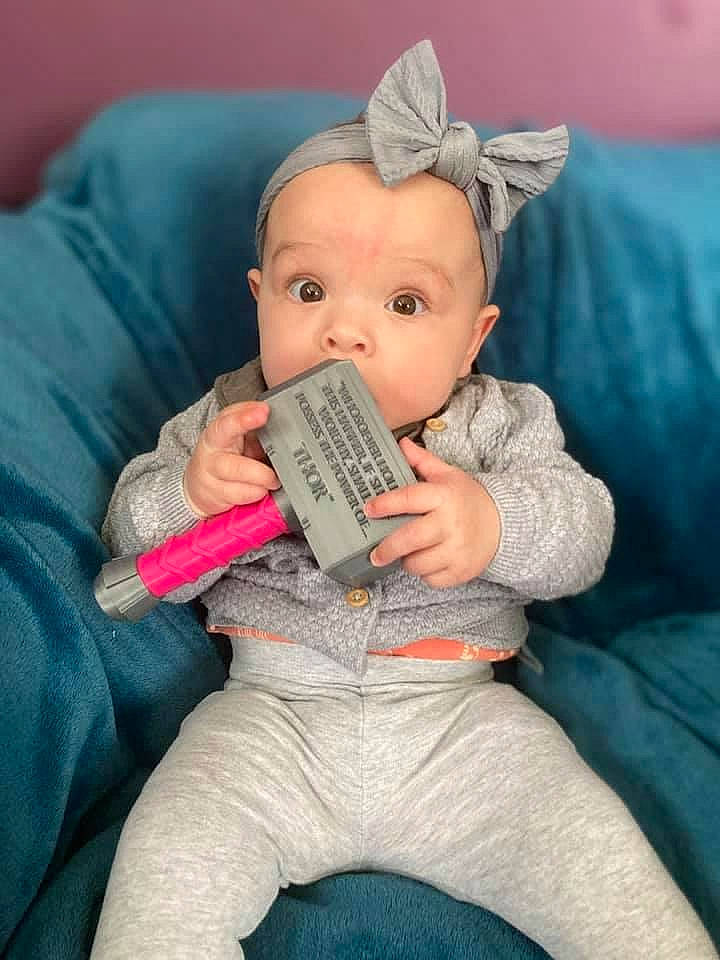 Amelia is registered to the contest to win money with this photo: baby, baby_toddler_clothing, cheek, comfort, ear, eye, finger, gesture, head, human_body, iris, lap, mouth, nose, person, skin, sleeve, stuffed_toy, textile, thumb