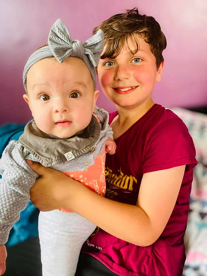 Amelia is registered to the contest to win money with this photo: baby, baby_toddler_clothing, clothing, facial_expression, flash_photography, fun, gesture, grass, hairstyle, happy, interaction, iris, joy, leisure, people_in_nature, person, pink, skin, smile, standing