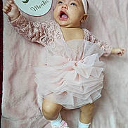Heart is registered to the contest to win money with this photo: baby, infant, girl, pink_dress, headband, socks, milestone_card, 3_months, blanket, lying_down, smiling, happy, cute, celebration, soft_texture, tulle, lace, child, portrait, person