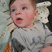 Waylon joined the competition — help win amazing prizes! baby, child, infant, face, blue_eyes, rosy_cheeks, blanket, onesie, animal_print, sleepwear, cute, indoors, soft_texture, expression, hand, lying_down, cozy, curious, skin, young