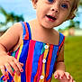 child, toddler, blue_eyes, blonde_hair, colorful_dress, striped_dress, outdoor, grass, sky, portrait, happy, cute, person, summer, nature, playful, fashion, small_child, smiling, closeup
