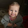 Juliette a rejoint le concours — aidez-le/la à gagner de superbes lots ! child, toddler, smile, portrait, sweater, knit_cardigan, blond_hair, blue_eyes, cheeks, hands, indoor, cozy, cute, looking_up, toothy_grin, patterned_floor, baby, poser, warm_lighting, closeup