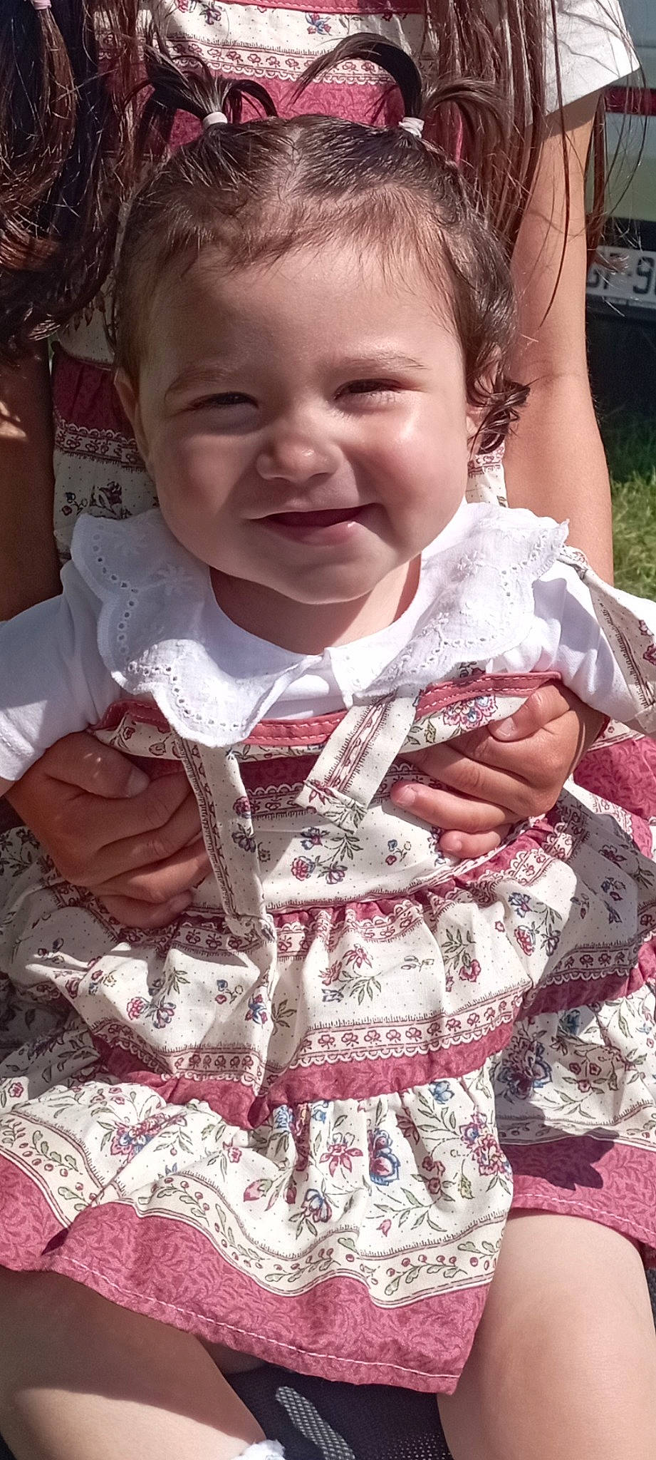 Grace participe au concours pour gagner de l'argent avec cette photo : baby_toddler_clothing, cheek, dress, eye, finger, gesture, hand, happy, iris, joy, lip, nose, organ, outerwear, person, pink, plant, skin, sleeve, smile