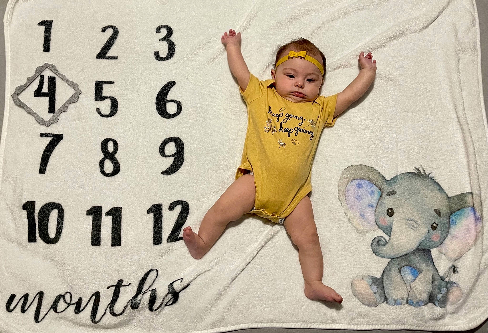 Tessa is registered to the contest to win money with this photo: arm, baby, baby_toddler_clothing, barefoot, child, comfort, facial_expression, finger, font, foot, fun, gesture, happy, mammal, person, sleeve, t_shirt, thigh, thumb, toddler