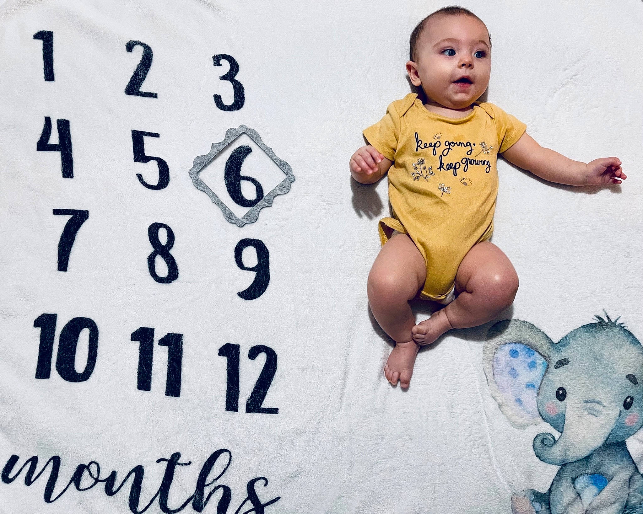 Tessa joined the competition — help win amazing prizes! baby, baby_toddler_clothing, barefoot, child, facial_expression, font, foot, fun, gesture, happy, head, leisure, logo, people_in_nature, person, photo_caption, play, sitting, sleeve, t_shirt