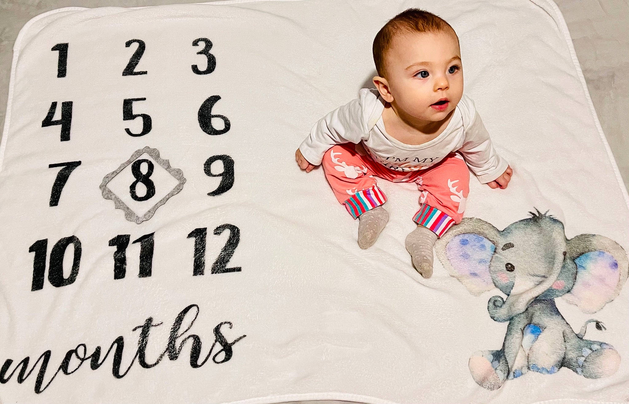 Tessa is registered to the contest to win money with this photo: baby, baby_toddler_clothing, child, comfort, design, facial_expression, flooring, font, happy, human, illustration, linens, people, person, product, rectangle, sleeve, stock_photography, t_shirt, textile