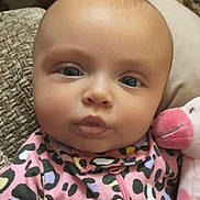 Delilah joined the competition — help win amazing prizes! baby, infant, face, eyes, cheeks, mouth, newborn, onesie, pink, plush_toy, stuffed_animal, leopard_print, pattern, close_up, portrait, indoor, pillow, blanket, adorable, clothing