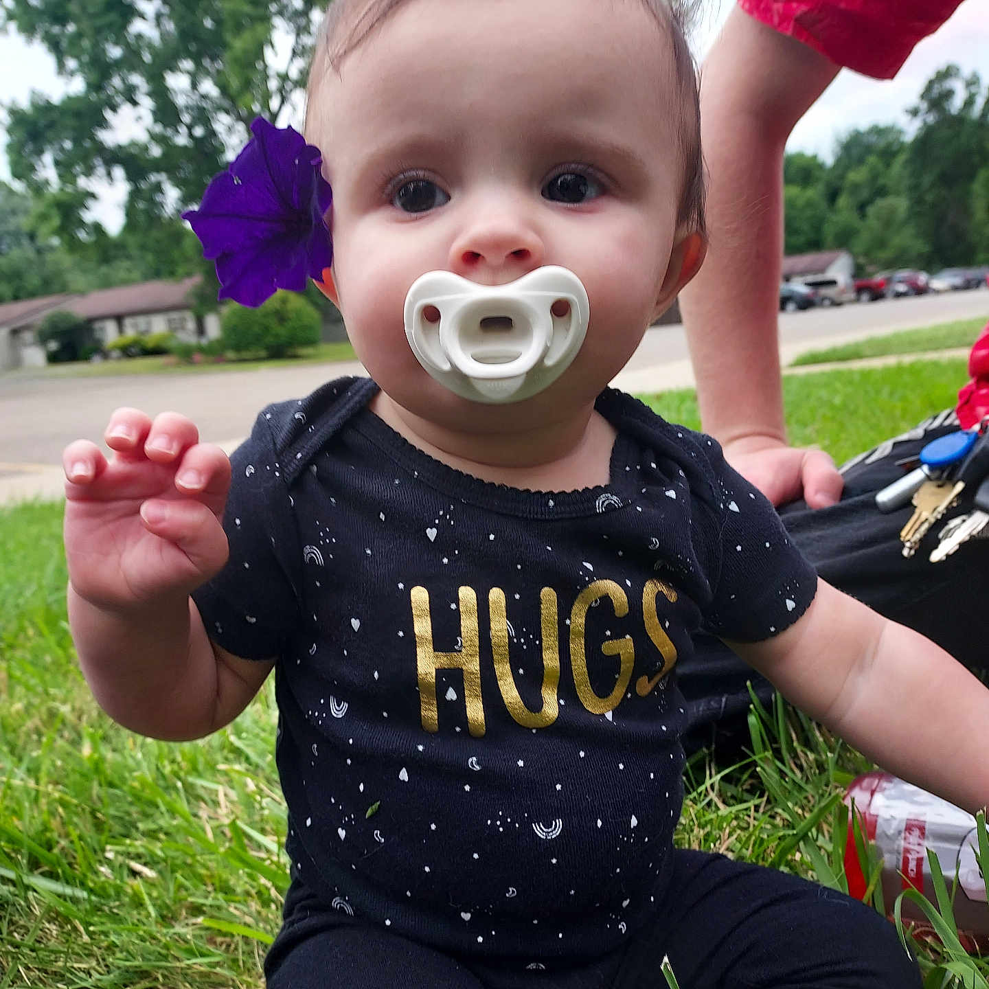 Serena Taylor is registered to the contest to win money with this photo: baby, bodypart, clothing, face, finger, flower, grass, hand, head, nature, outdoors, pants, park, person, petal, photography, plant, portrait, t_shirt, tree