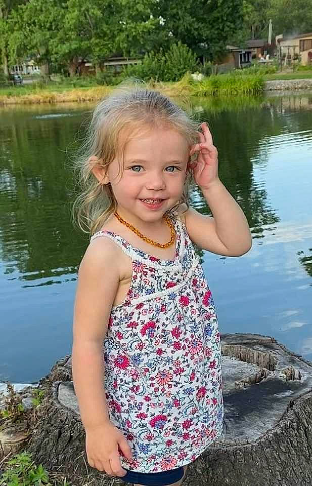 Austyn is registered to the contest to win money with this photo: bank, botany, fun, grass, hair, hand, happy, iris, joy, lake, leaf, leisure, nature, people_in_nature, person, plant, smile, summer, tree, water
