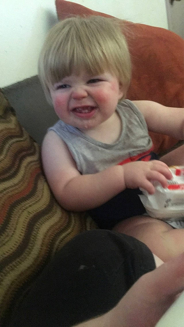 Walter is registered to the contest to win money with this photo: baby, baby_toddler_clothing, blond, cheek, child, chin, comfort, finger, flooring, fun, hairstyle, happy, head, iris, mouth, nose, person, sitting, skin, smile