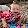 baby, child, toy, piano, carpet, indoor, smiling, happy, playful, red_striped_clothing, hand, face, furniture, footwear, home, floor, head, expression, infant, colorful