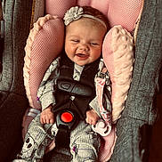 Kyah Kay is registered to the contest to win money with this photo: baby, car_seat, pajamas, pink, headband, smiling, pacifier, infant, clothing, happy, child, seatbelt, comfort, cute, indoors, closeup, fabric, toy, safety, person