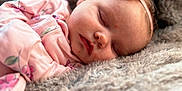 Kyah Kay is registered to the contest to win money with this photo: baby, sleeping, pink, headband, flower, blanket, soft, cozy, infant, portrait, closeup, peaceful, cute, child, resting, clothing, fuzzy, face, newborn, indoors