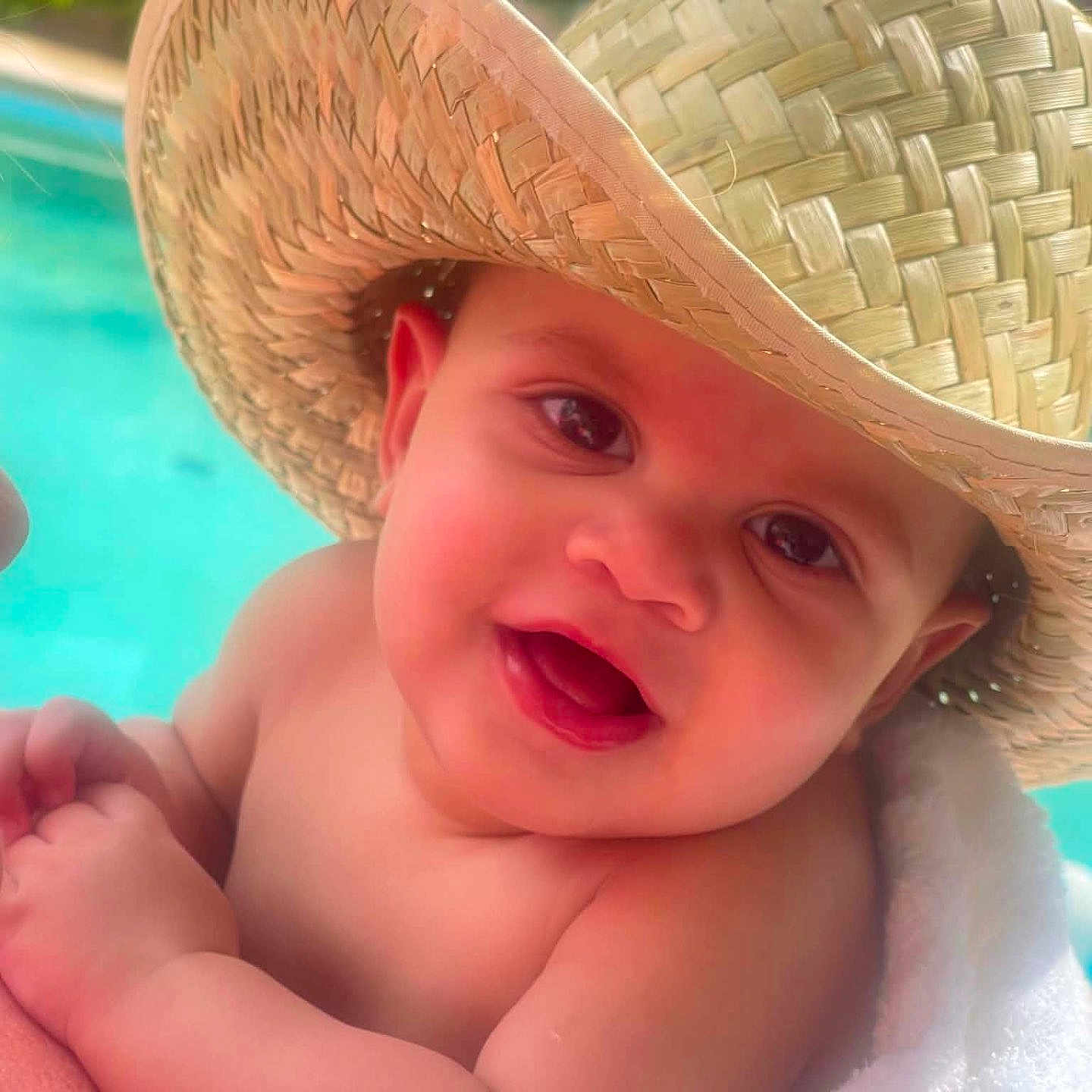 Andre joined the competition — help win amazing prizes! baby, smiling, hat, straw_hat, towel, pool, water, outdoor, child, face, happy, skin, closeup, summer, nature, greenery, cute, portrait, person, sunlight
