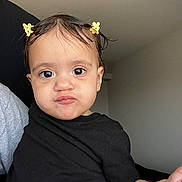 Lyett is registered to the contest to win money with this photo: toddler, child, baby, face, expression, hair_clip, black_shirt, indoor, person, skin, cute, pout, portrait, holding, young_child, head, eyes, hand, funny_face, hair