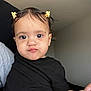toddler, child, baby, face, expression, hair_clip, black_shirt, indoor, person, skin, cute, pout, portrait, holding, young_child, head, eyes, hand, funny_face, hair